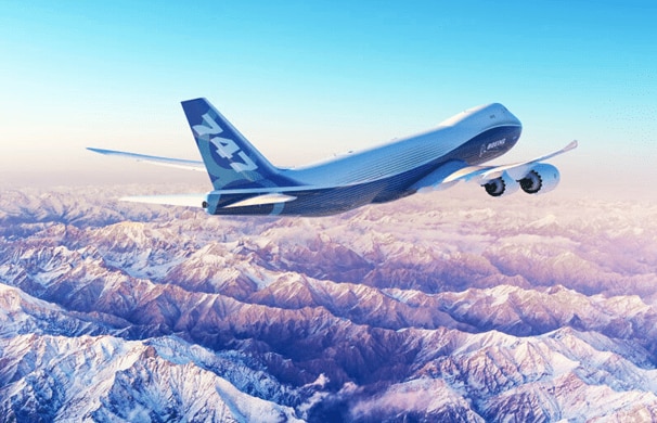 Boeing 747 flying over snowy mountains